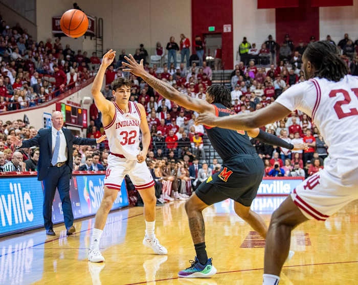 Indiana University's Trey Galloway (32) passes around Maryland's Julian Reese (10) during the first half of the Indiana versus Maryland men's basketball game.